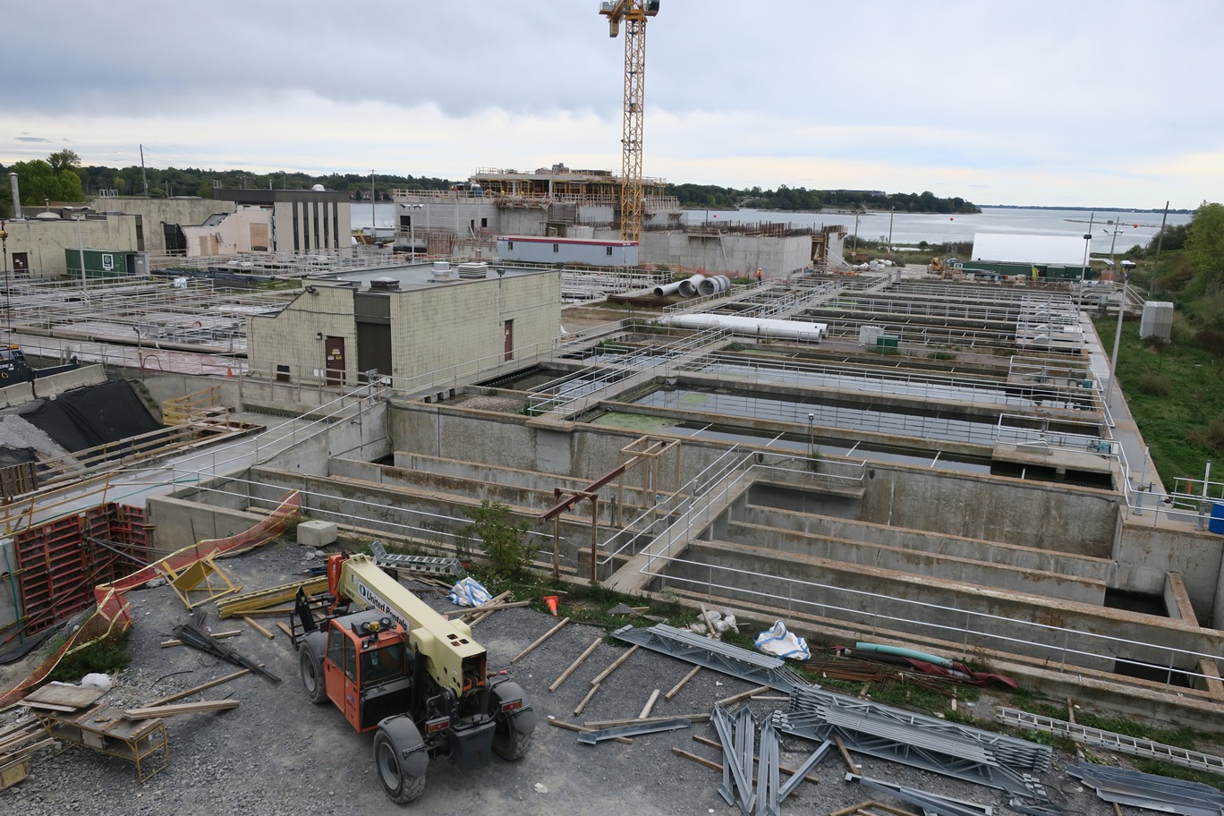 View from the top of the new dewatering building, looking at the existing plant and new construction of biological aerated filter (BAF) facility building. The plant upgrade will improve the quality of treated wastewater that is discharged to Lake Ontario in the form of natural resource quality water. 