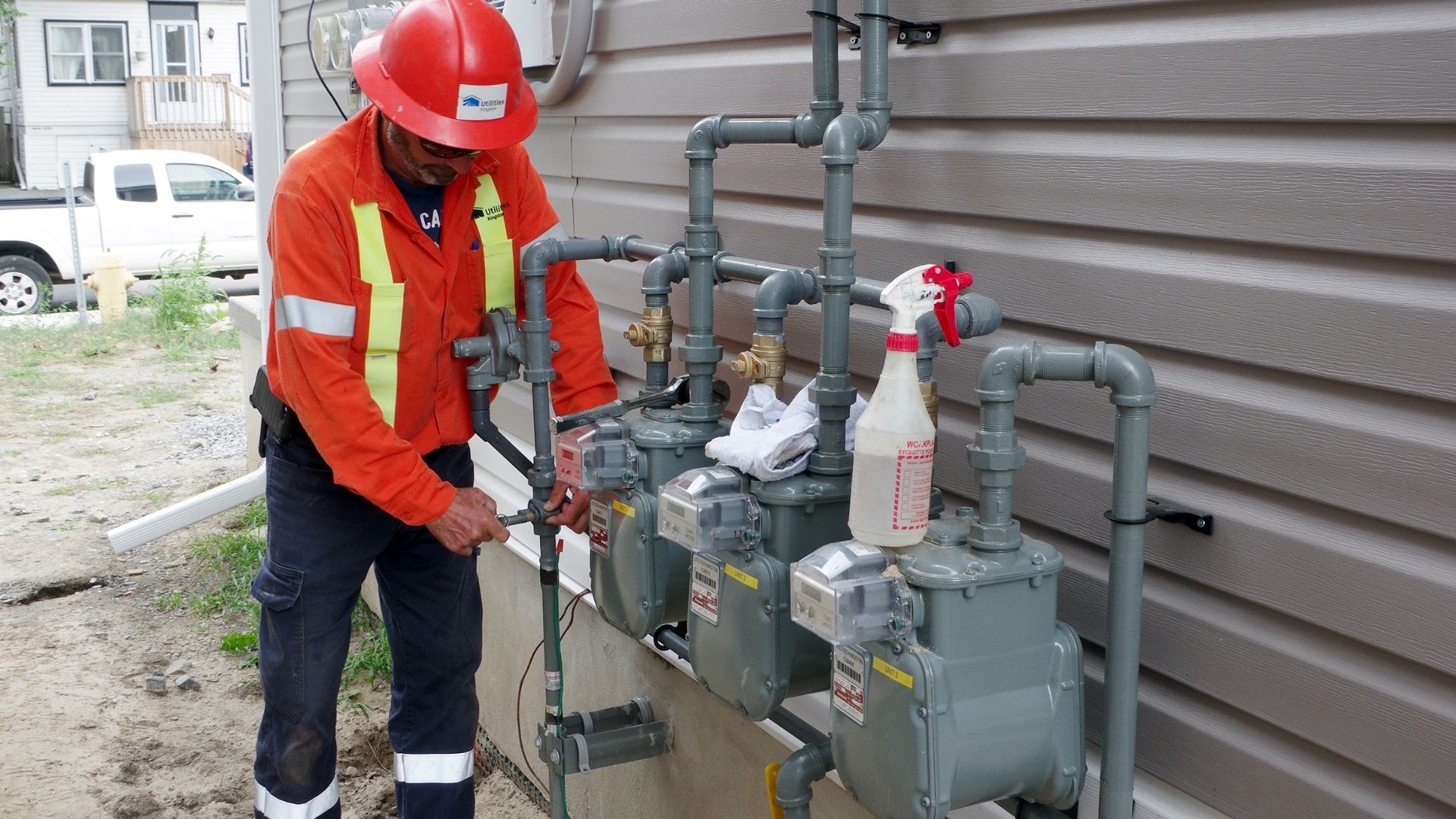 A gas technician completes meter work